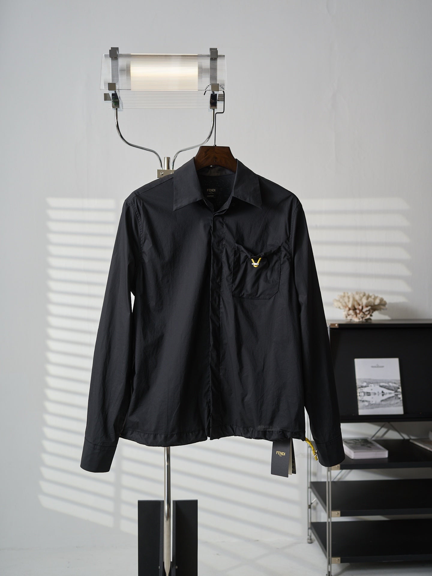 Fendi dark long jacket with stand collar and chest logo patch, front view
