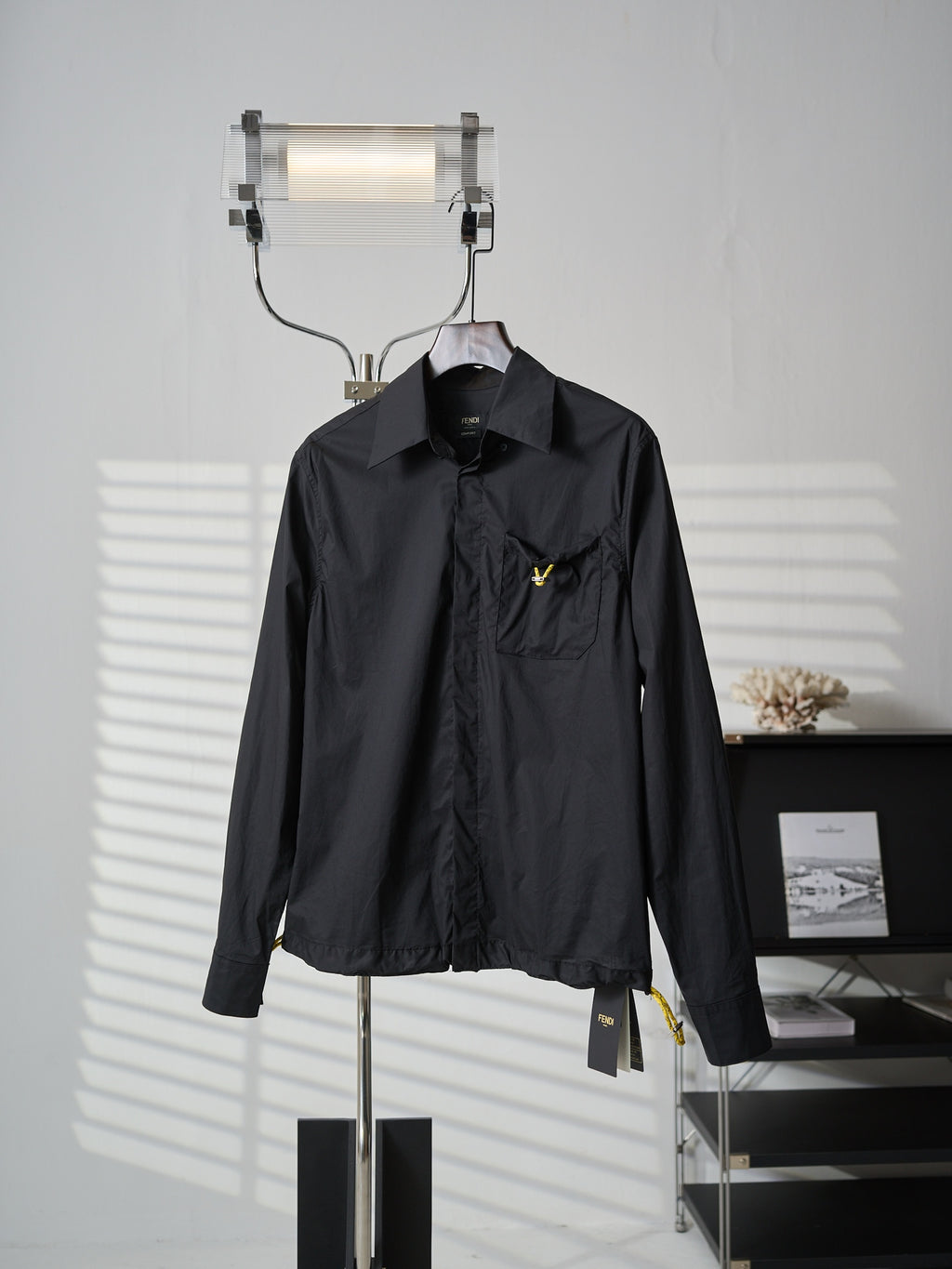 Fendi dark long jacket front view with stand collar and chest pocket logo