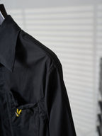 Fendi dark long jacket side view with shoulder seam and small yellow logo