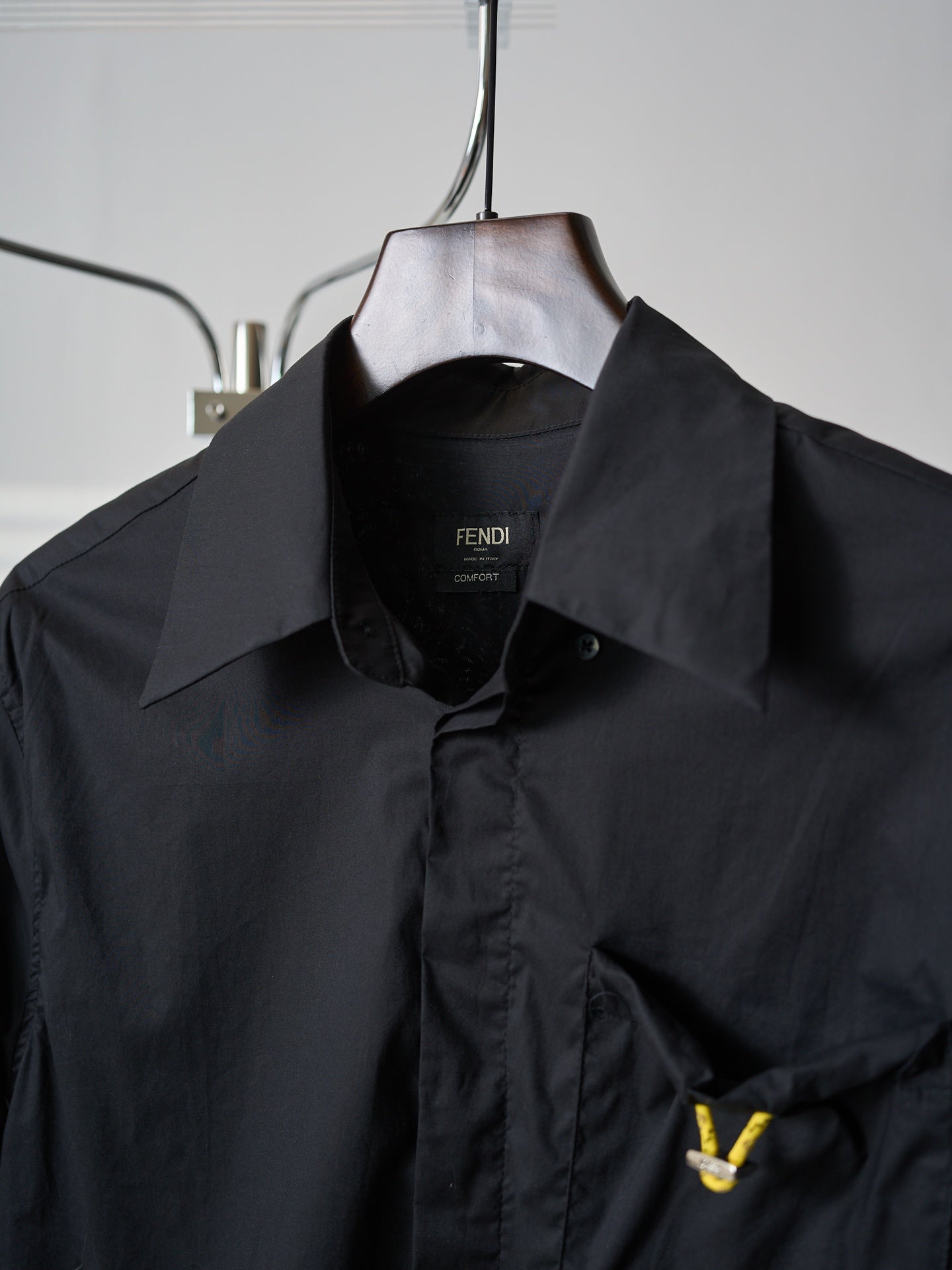 Fendi dark long jacket close-up of stand collar and front button placket