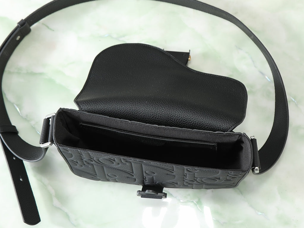 Dior black crossbody bag open with embossed front panel and crossbody strap