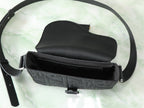 Dior black crossbody bag open with embossed front panel and crossbody strap