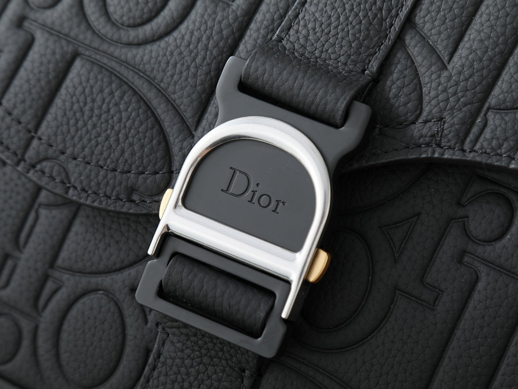 Dior bag hardware clasp with Dior logo on black leather texture