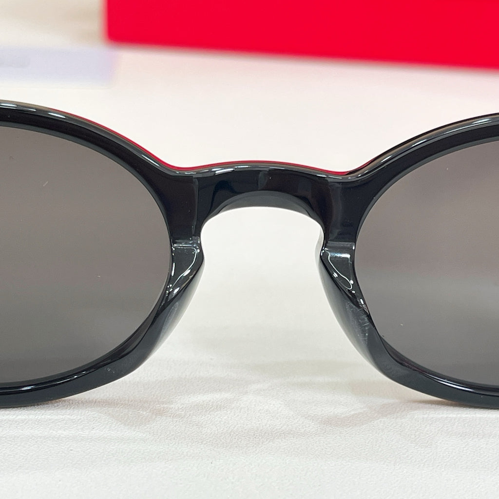 YSL round sunglasses with dark lenses and glossy black frame