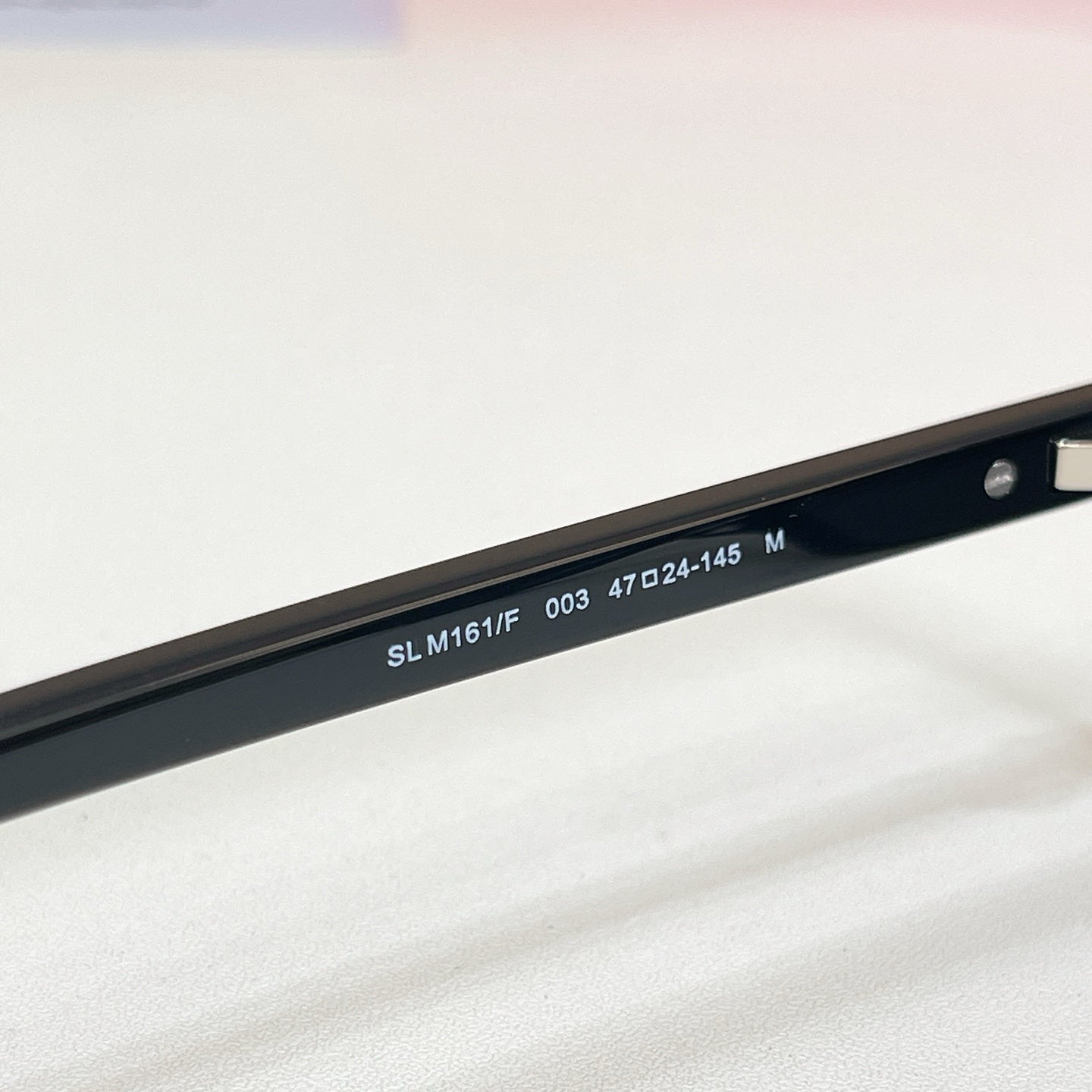 YSL sunglasses temple with model numbers on dark frame