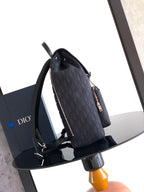 Navy Dior backpack side view with shoulder straps and zipper pocket