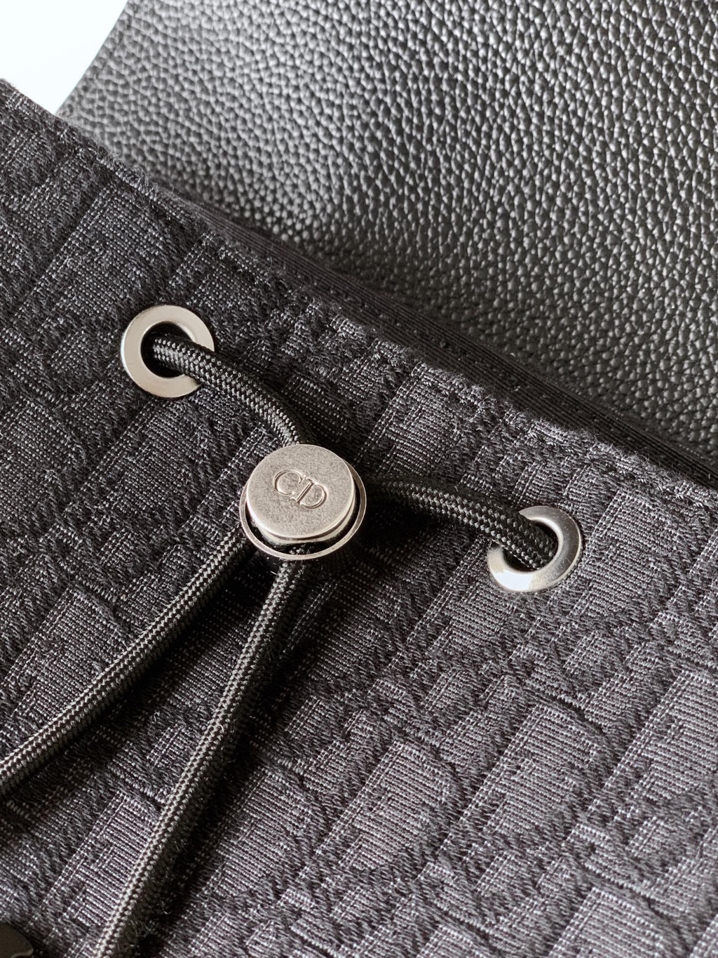 Dark bag pocket with silver snap button and grommet rings