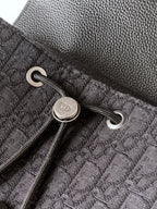 Dark bag pocket with silver snap button and grommet rings