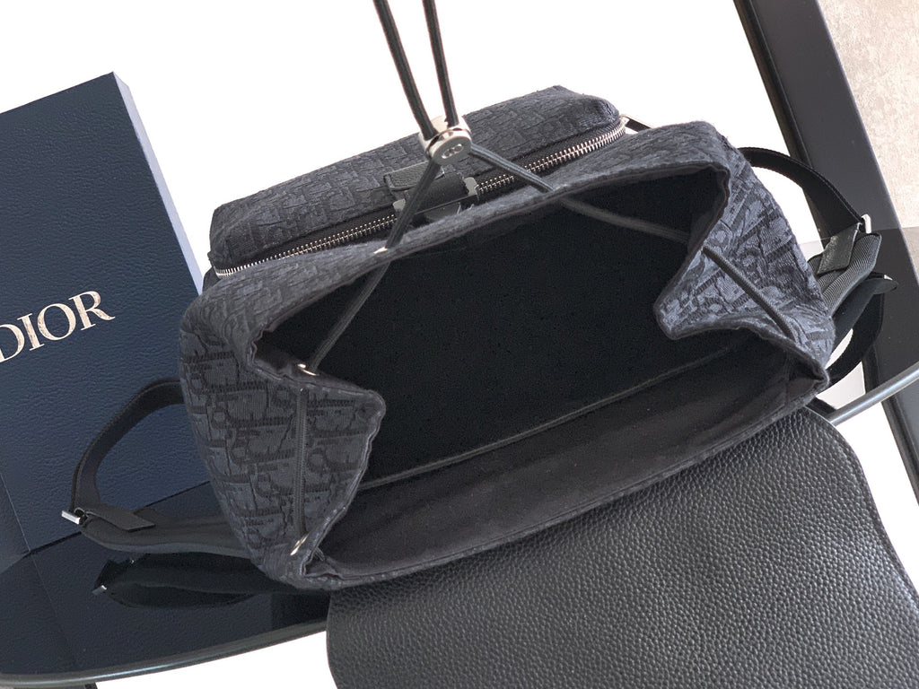 Open-top Dior bag showing dark interior and zipper opening