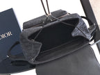 Open-top Dior bag showing dark interior and zipper opening
