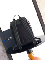 Black Dior backpack with top handle and pleated front organizer sections