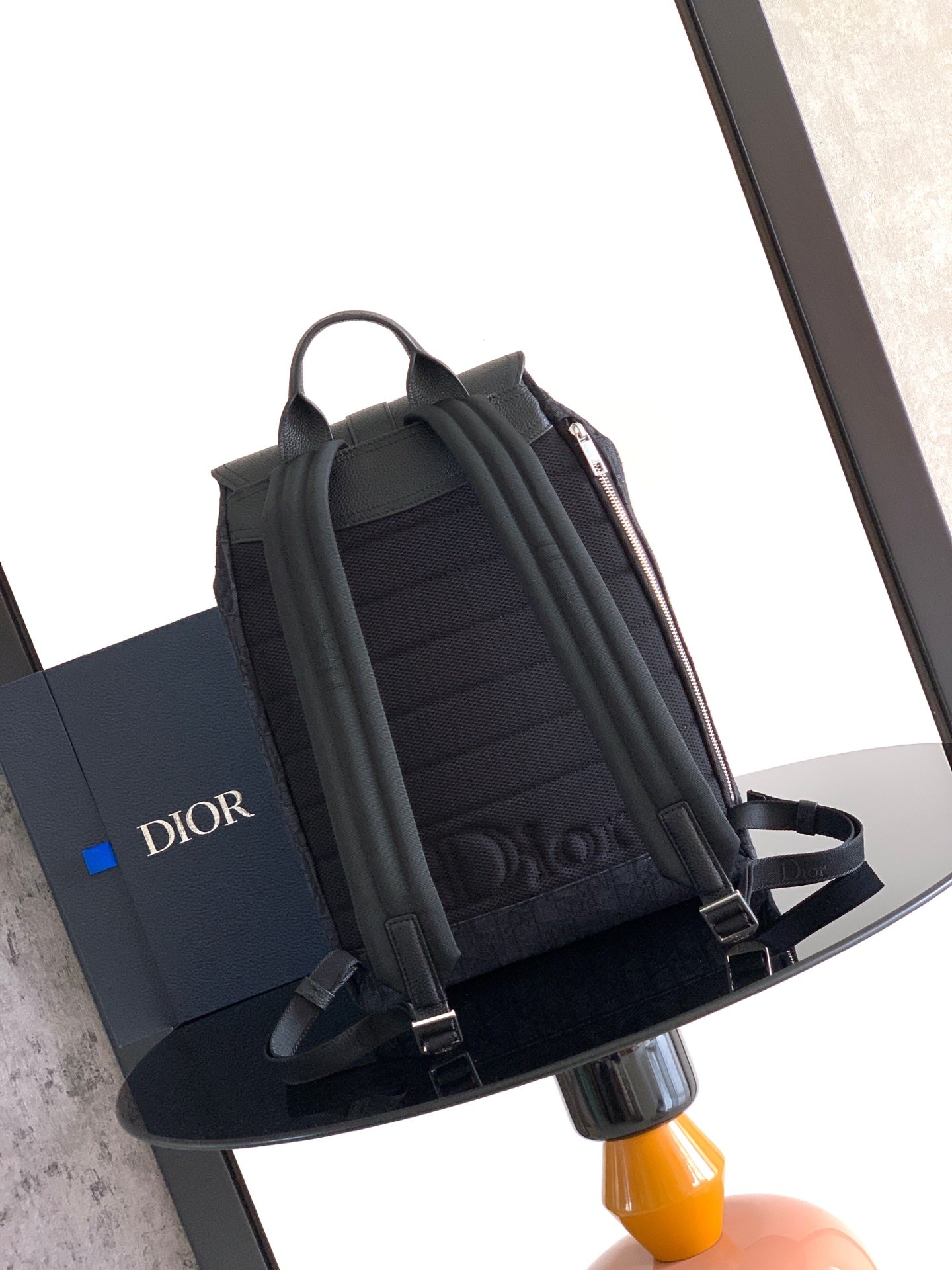 Black Dior backpack with top handle and pleated front organizer sections