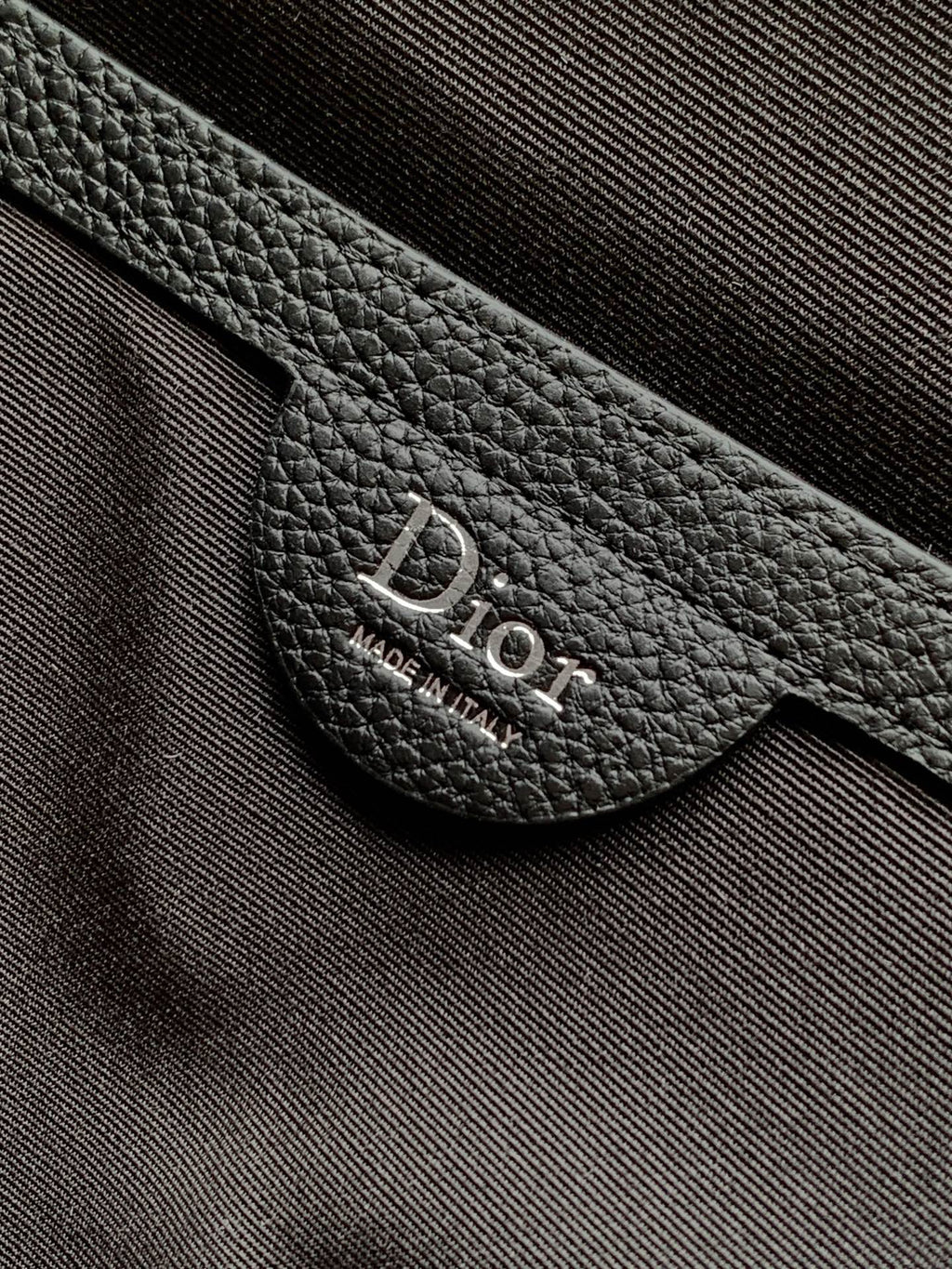 Black leather Dior logo patch on strap near metal ring