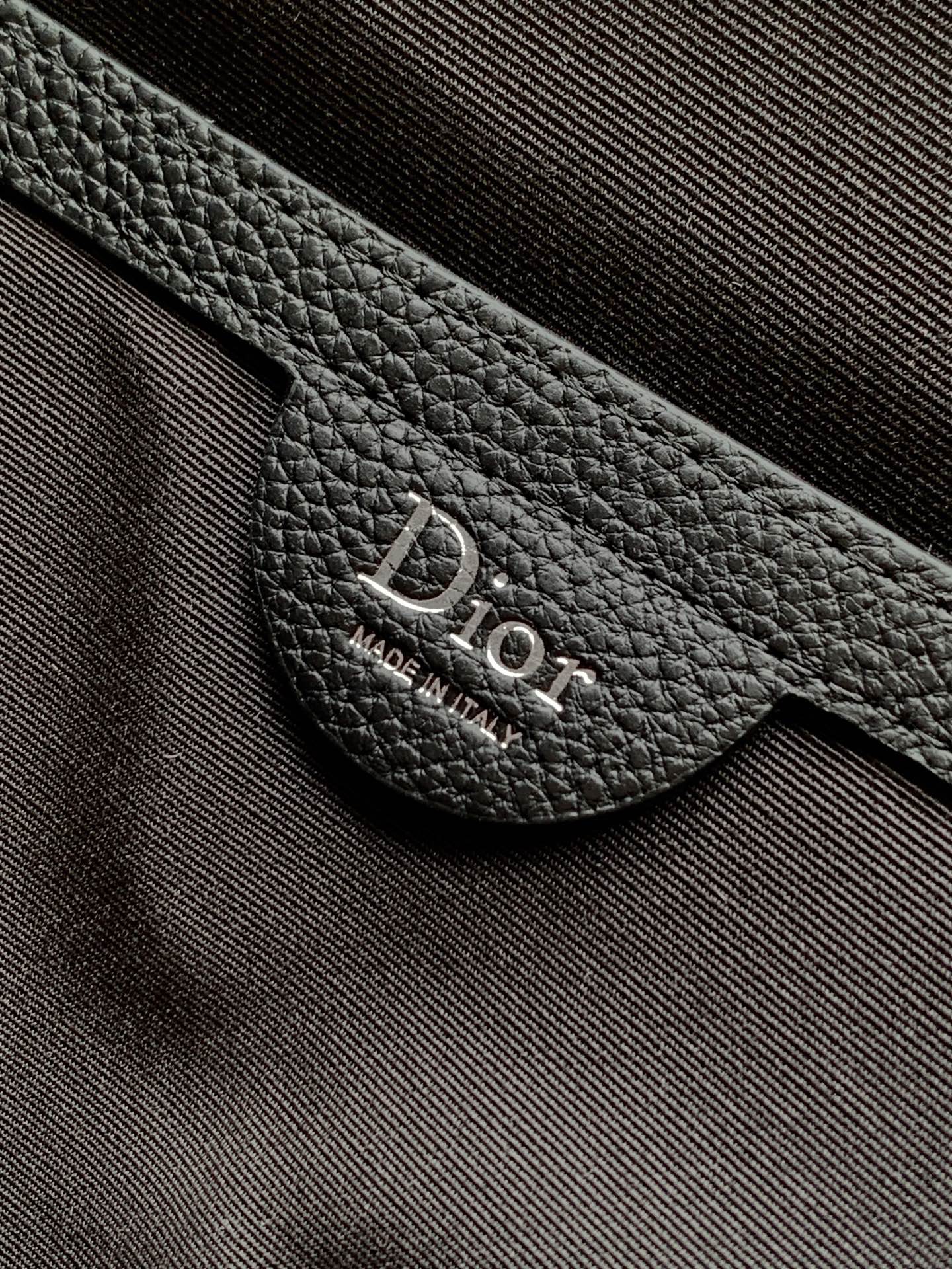 Black leather Dior logo patch on strap near metal ring
