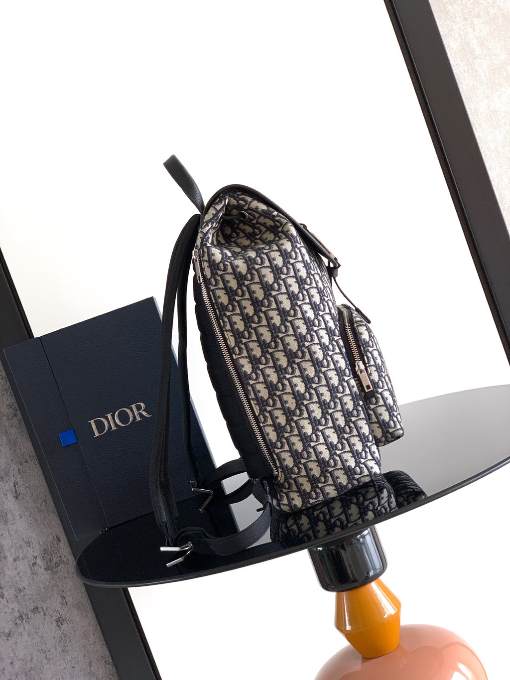 Dior monogram backpack with black side straps and adjustable shoulder strap