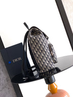 Dior monogram backpack with black side straps and adjustable shoulder strap