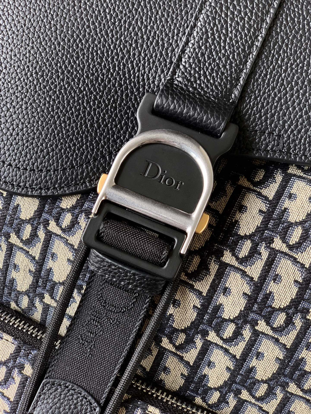 Dior logo buckle on black leather strap