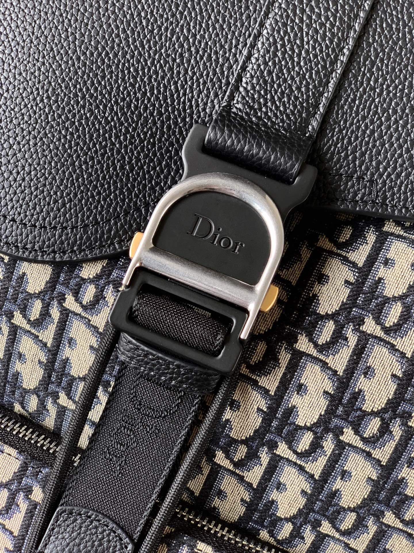 Dior logo buckle on black leather strap