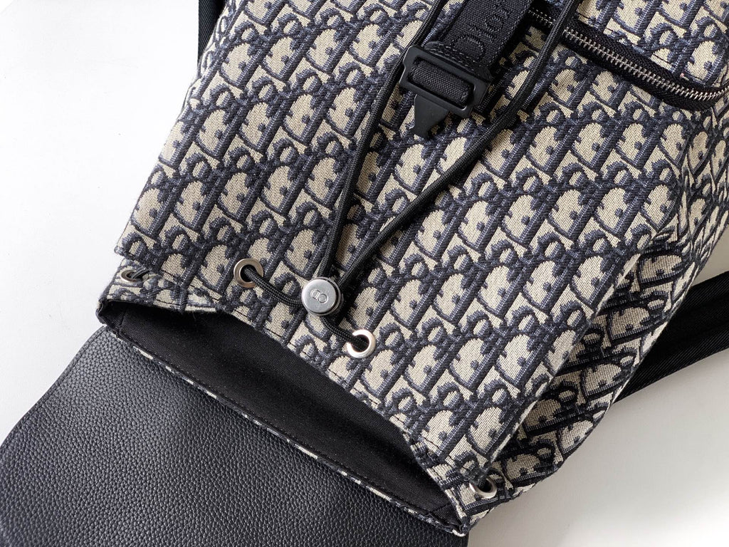 Dior monogram canvas with black zipper pull and small snap closure