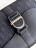 Dior bag close-up: metal buckle on embossed leather strap