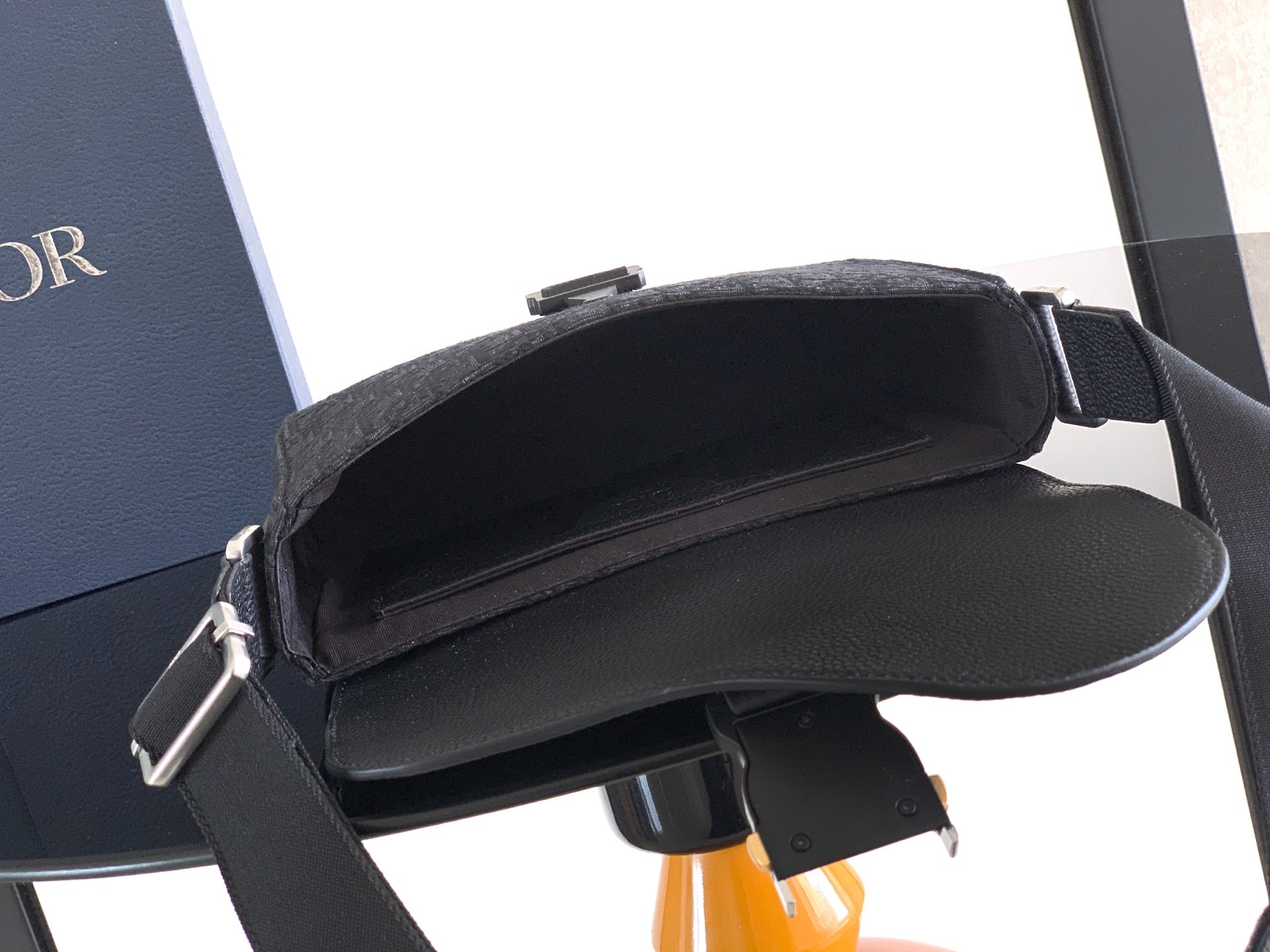Dior flap crossbody bag open to show inner compartment