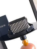 Dior crossbody bag with navy-beige patterned canvas and wide black strap