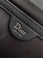 Dior bag leather patch with 'DIOR' text and 'MADE IN ITALY'
