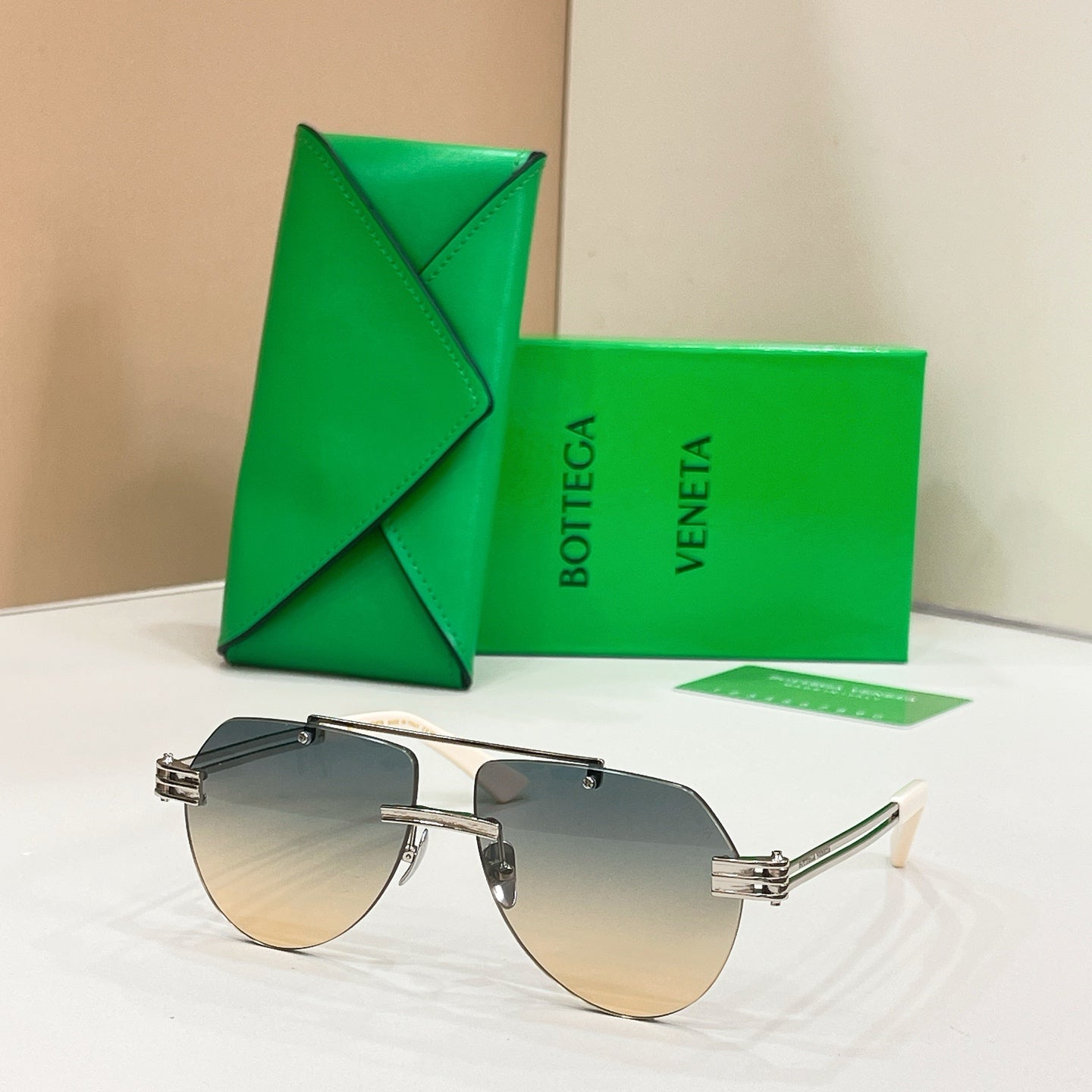 Gold metal sunglasses with gradient amber lenses and slim rectangular frames