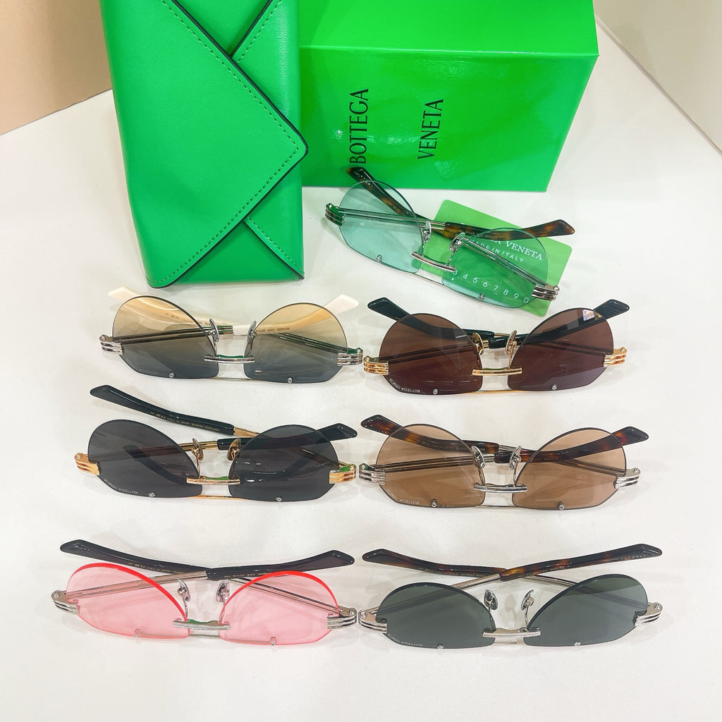 Assorted sunglasses with different colored lenses and metal frames, displayed together