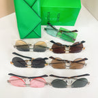 Assorted sunglasses with different colored lenses and metal frames, displayed together