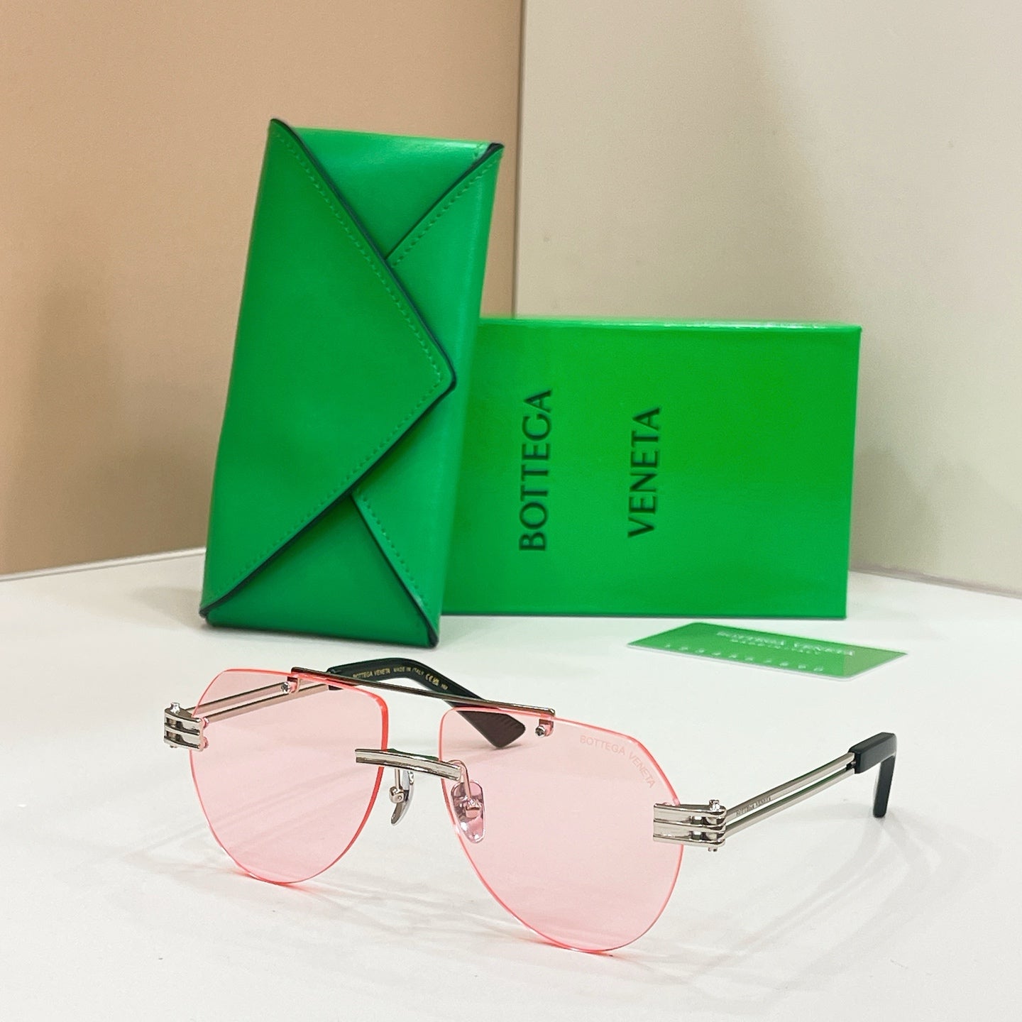 Rose gold sunglasses with pink lenses and slim rectangular frames