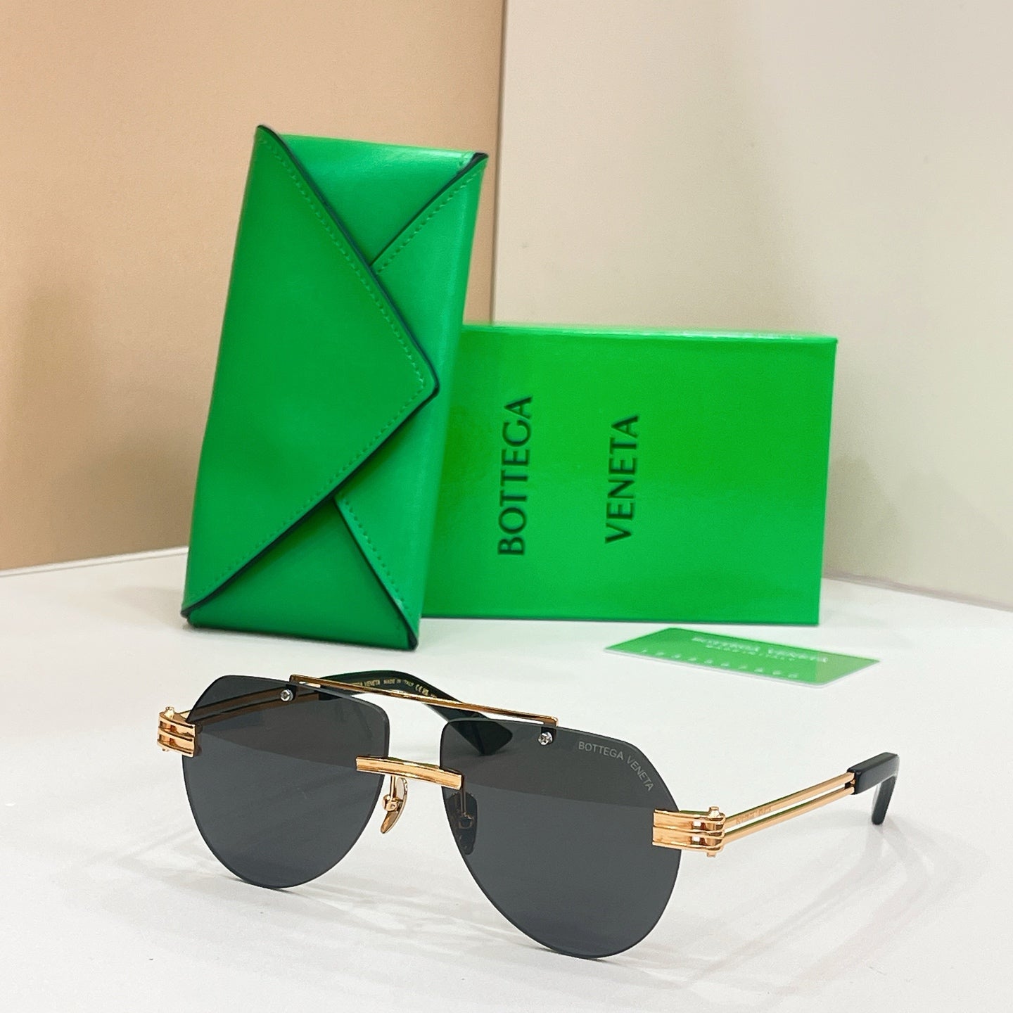 Gold metal sunglasses with dark lenses and slim rectangular frames