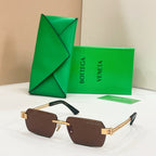 Bottega Veneta sunglasses with brown lenses, gold-tone frames, and tortoise-detail temples