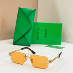 Bottega Veneta sunglasses with amber-orange lenses, gold-tone frames, and tortoise-detail temples