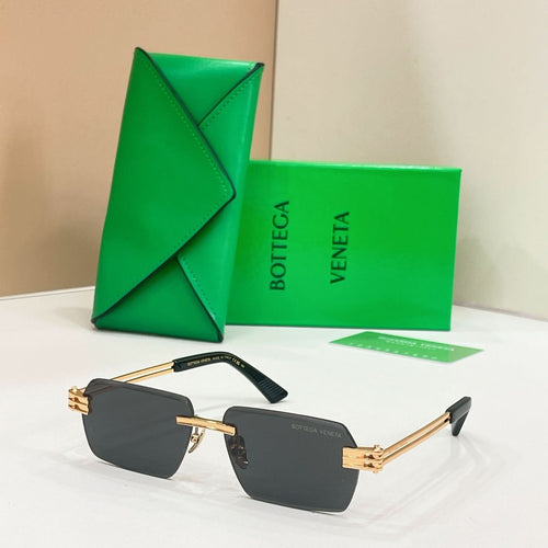 Bottega Veneta sunglasses with dark lenses, gold-tone frames, and tortoise-detail temples