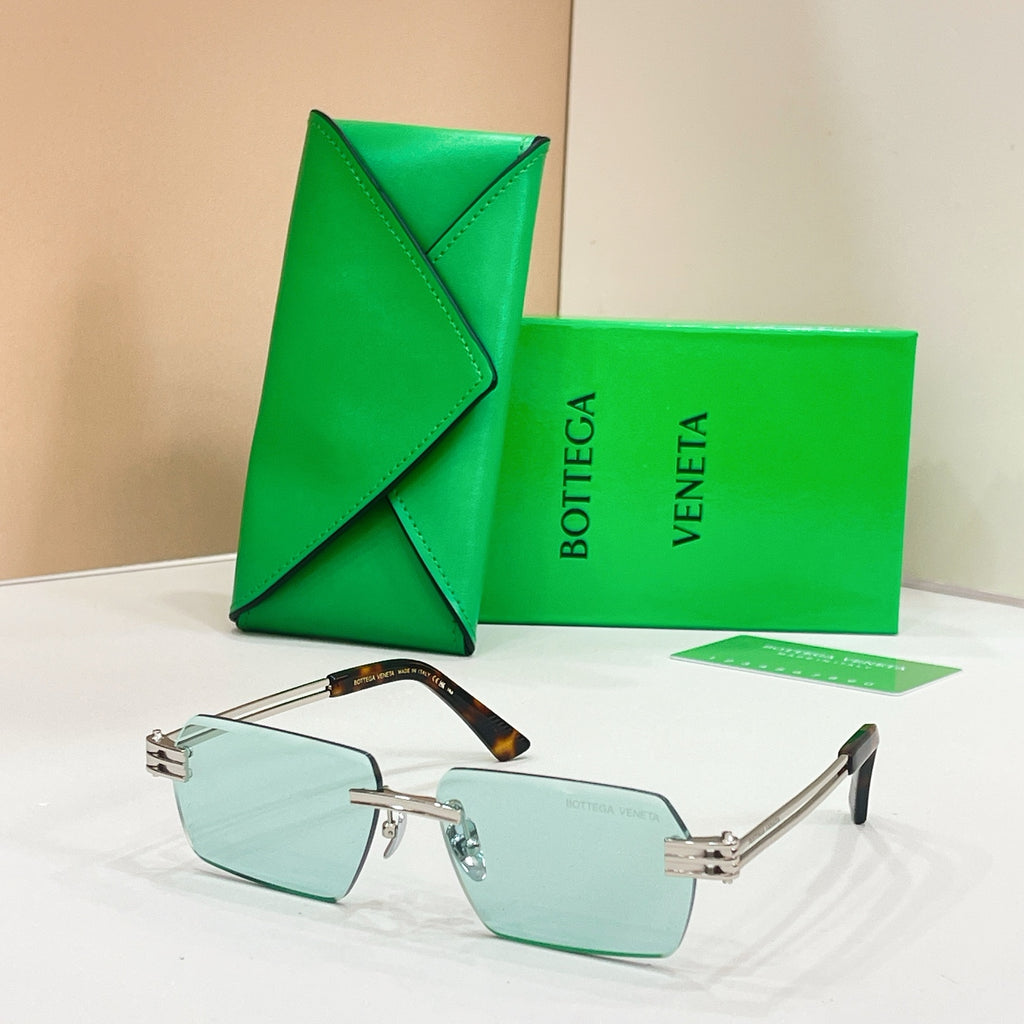 Bottega Veneta sunglasses with pale green-tinted lenses, silver-tone frames, and tortoise-detail temples
