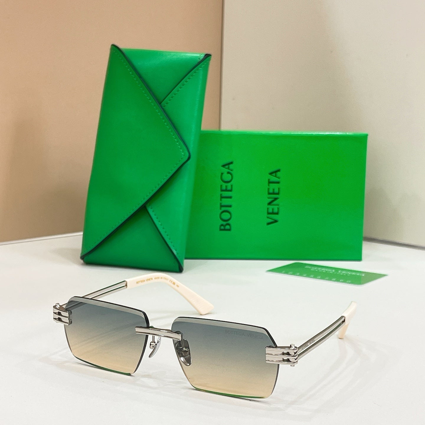 Bottega Veneta sunglasses with light blue lenses, silver-tone frames, and tortoise-detail temples