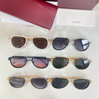 Multiple Gucci sunglasses laid out, mixed frames including white/gold, tortoiseshell, and dark