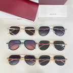 Multiple Gucci sunglasses laid out, assorted frames with dark lenses in rows