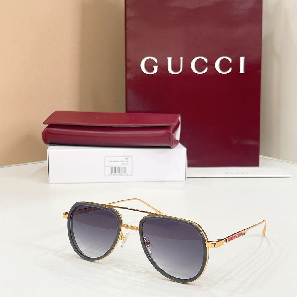 Gucci sunglasses with gold-tone rims, dark lenses, and black temples