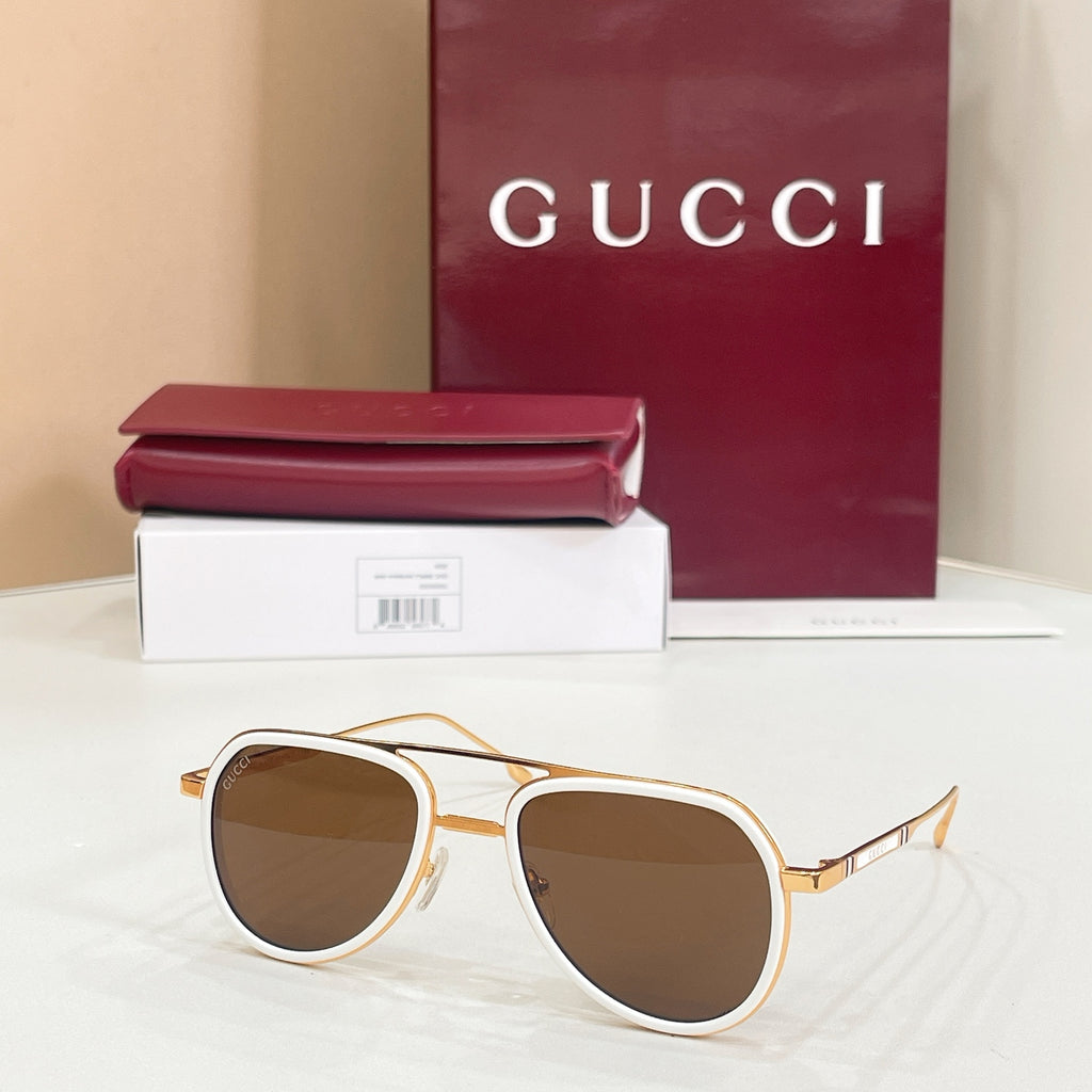Gucci sunglasses with white frame, gold-tone edges, and brown lenses