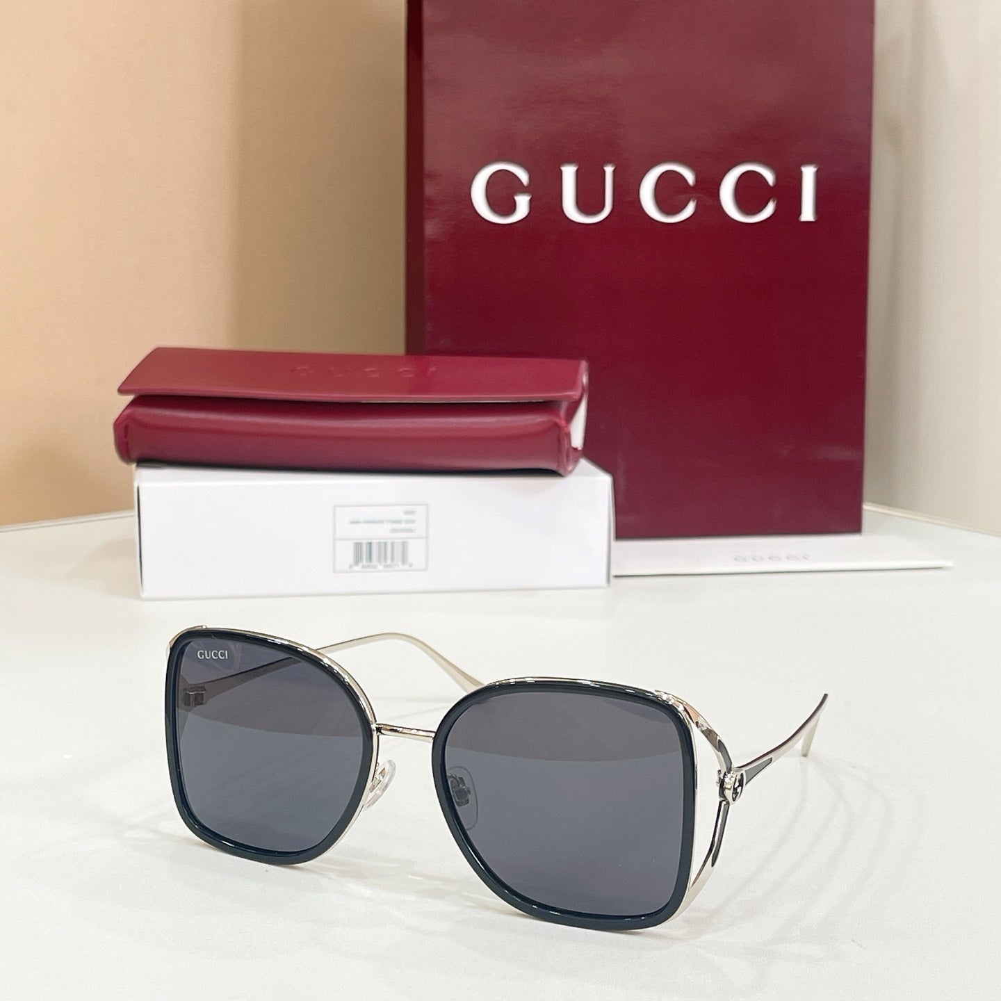 Gucci sunglasses with charcoal lenses and dark navy rounded frames