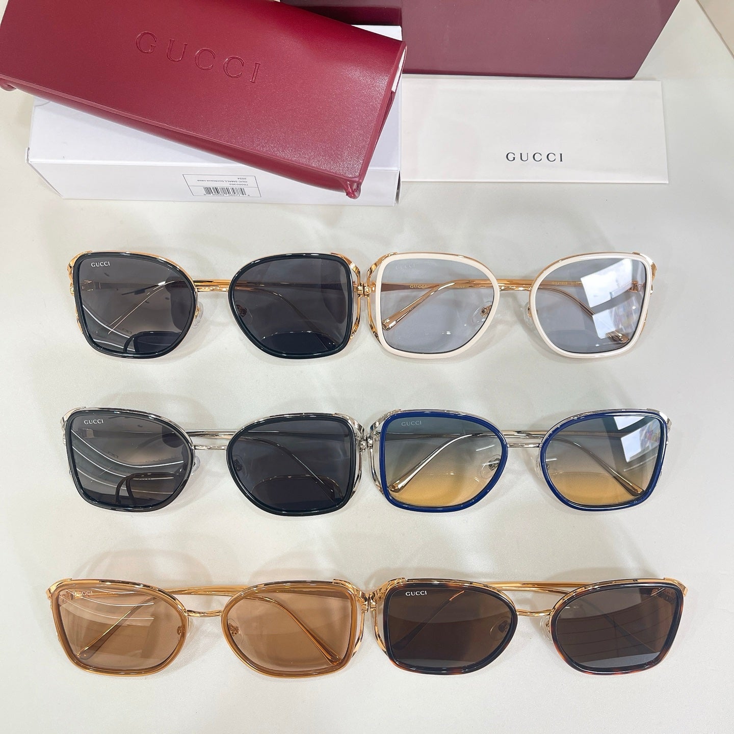 Gucci sunglasses set of four pairs in black, blue, and tan frames