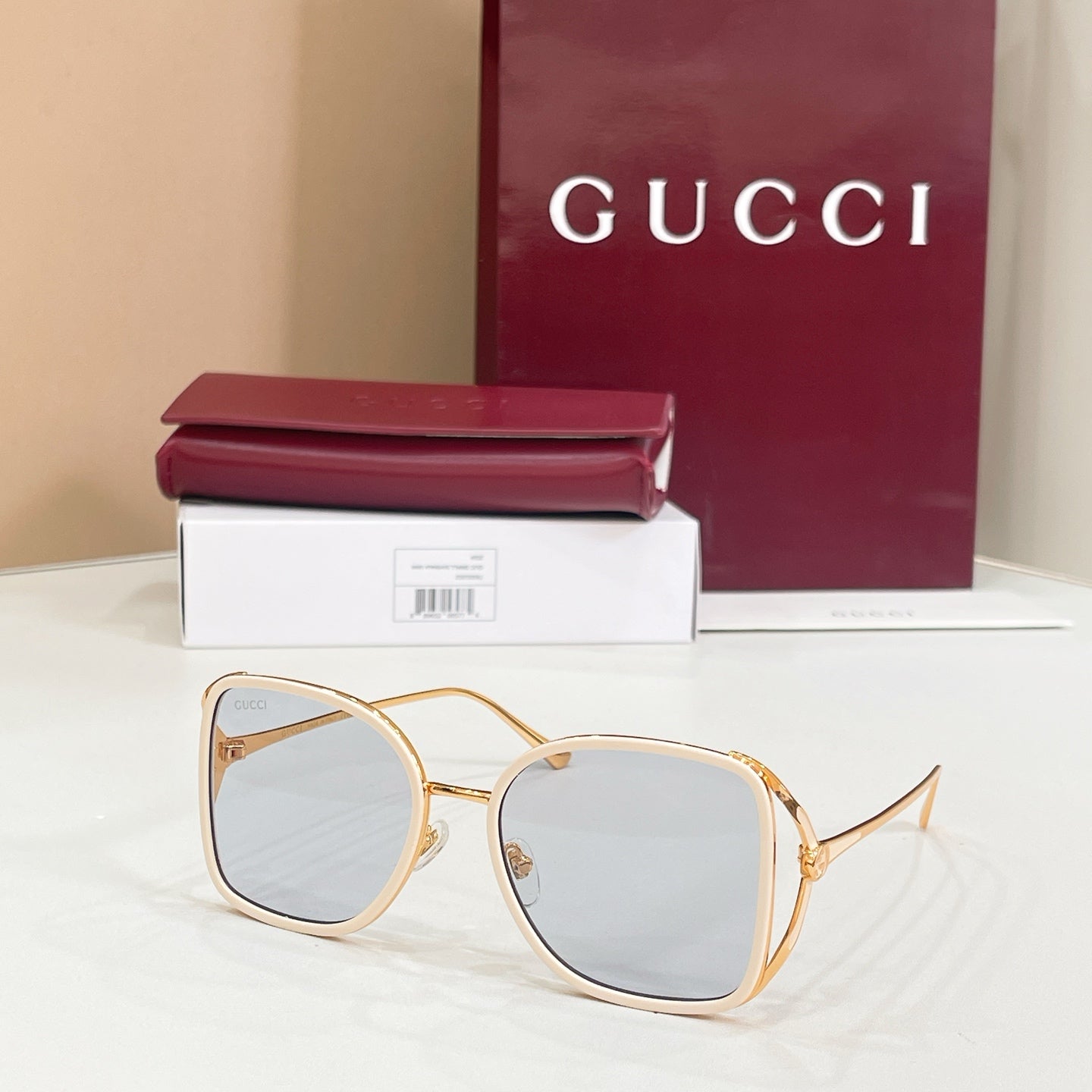 Gucci sunglasses with light blue lenses and gold-tone rounded frames