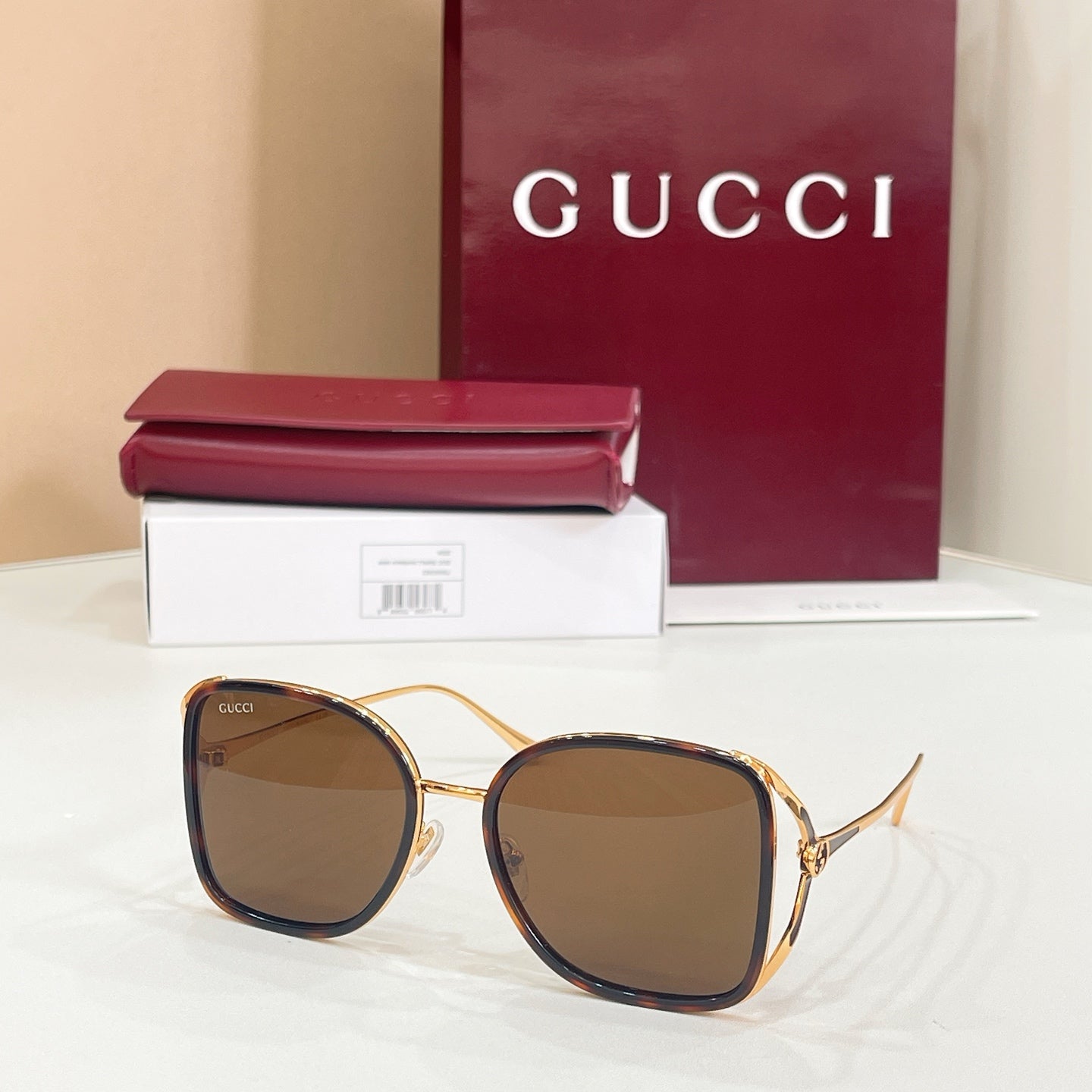 Gucci sunglasses with dark brown lenses and gold-tone rounded frames