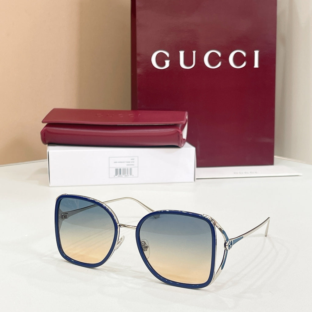 Gucci sunglasses with reflective blue lenses and navy-tone rounded frames