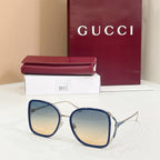 Gucci sunglasses with reflective blue lenses and navy-tone rounded frames