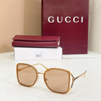 Gucci sunglasses with amber-tinted lenses and tan rounded frames