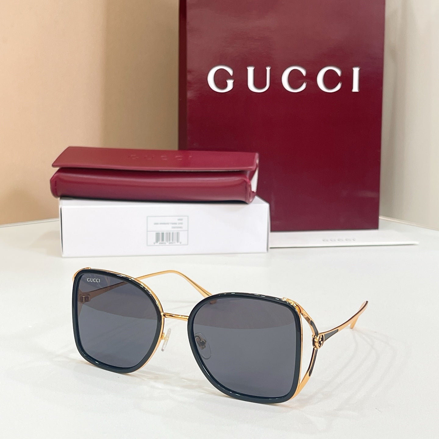 Gucci sunglasses with dark lenses and dark navy rounded frames