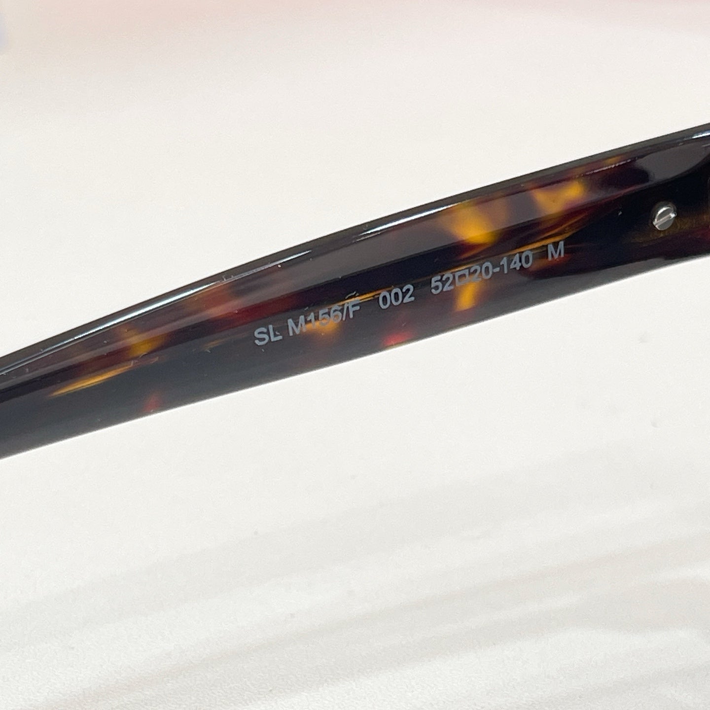 YSL sunglasses arm with printed numbers, tortoise frame and dark lenses